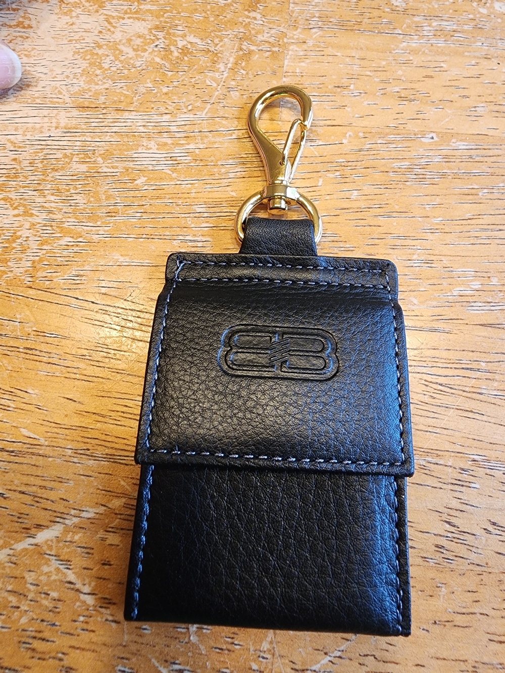 Balenciaga black leather keychain features a prominent embossed BB logo
